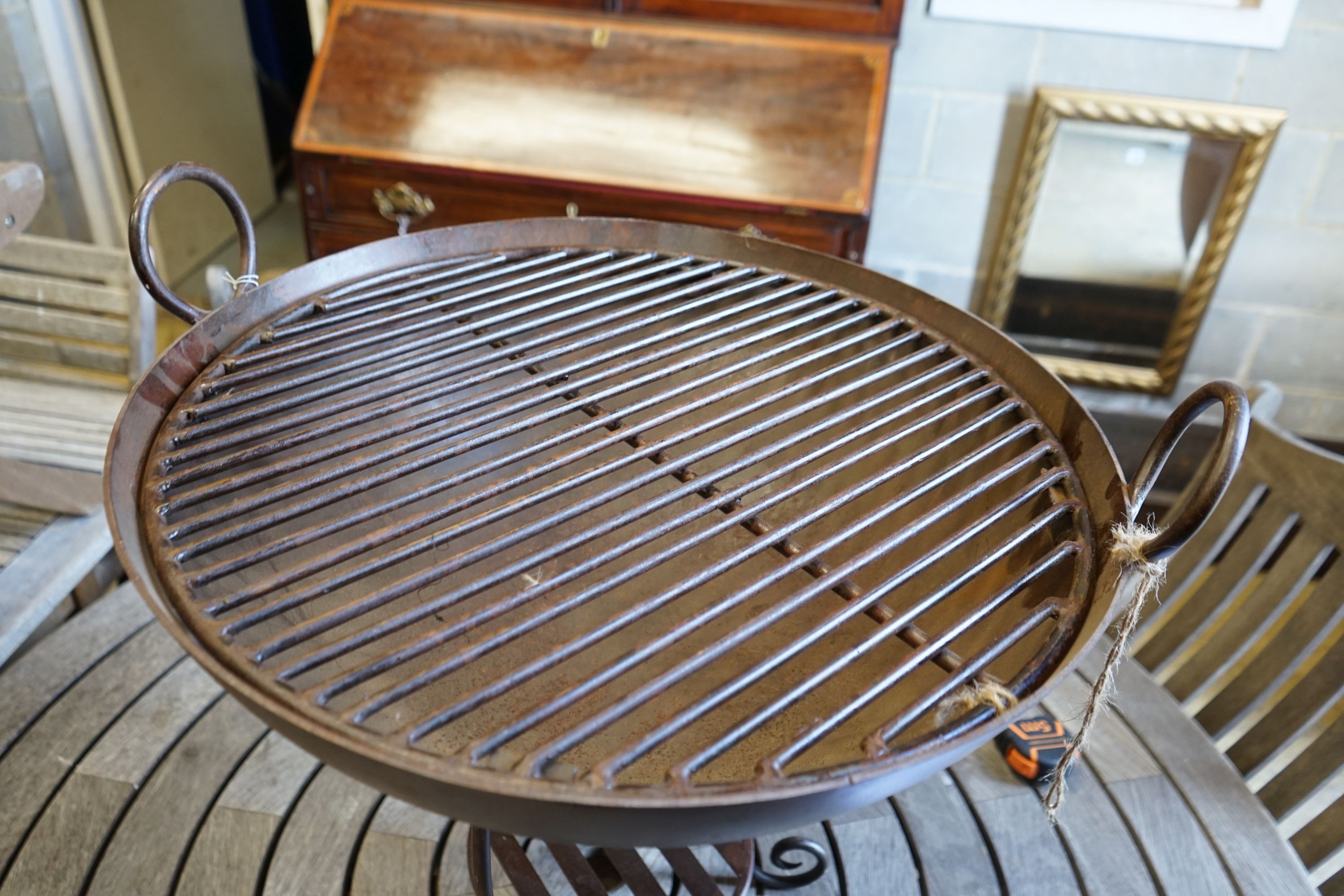 A wrought iron fire pit, diameter 61cm height 57cm